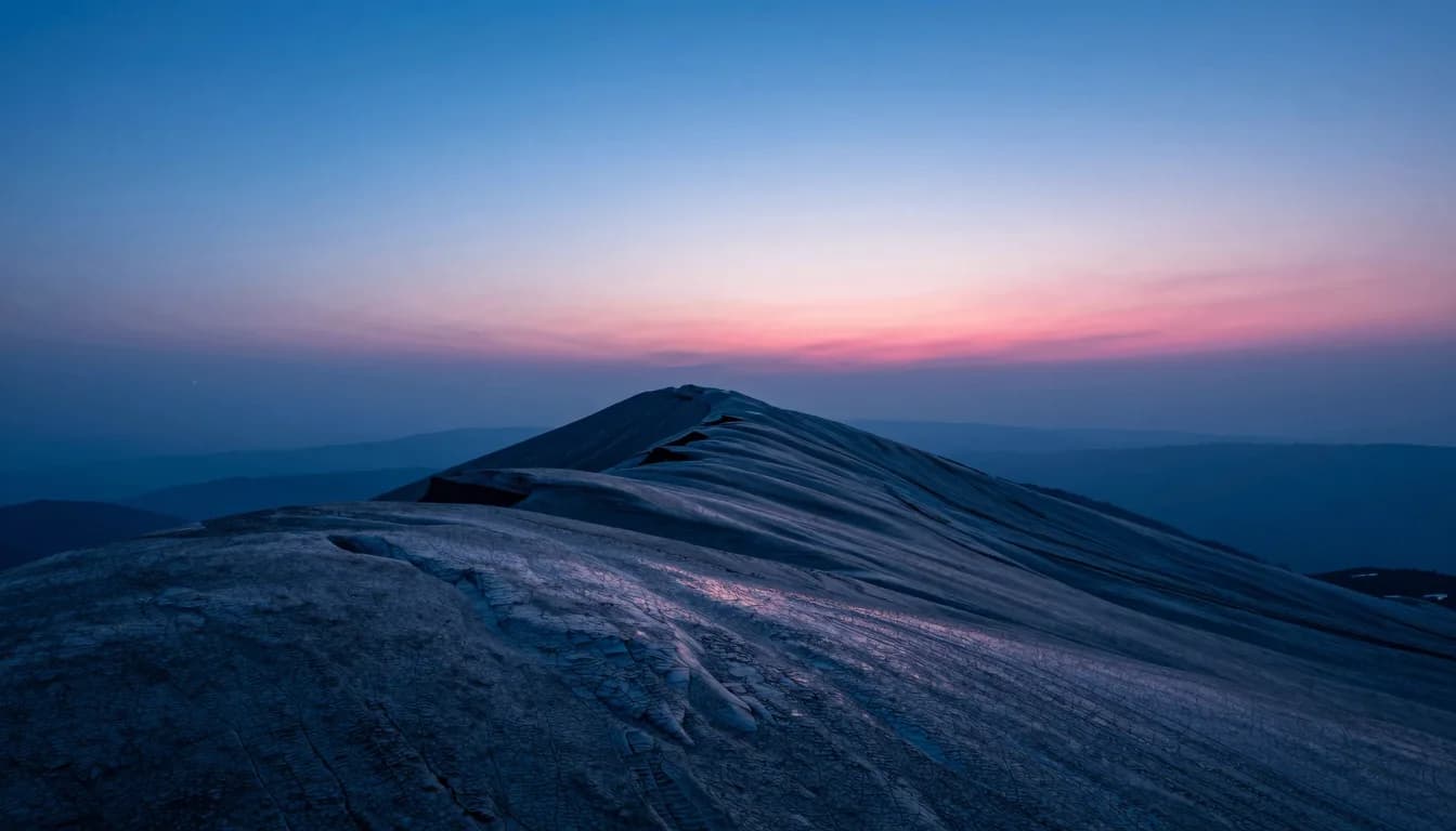 Ultra-wide distant shot of an ice cave mouth as a small bright opening in a vast cold field.