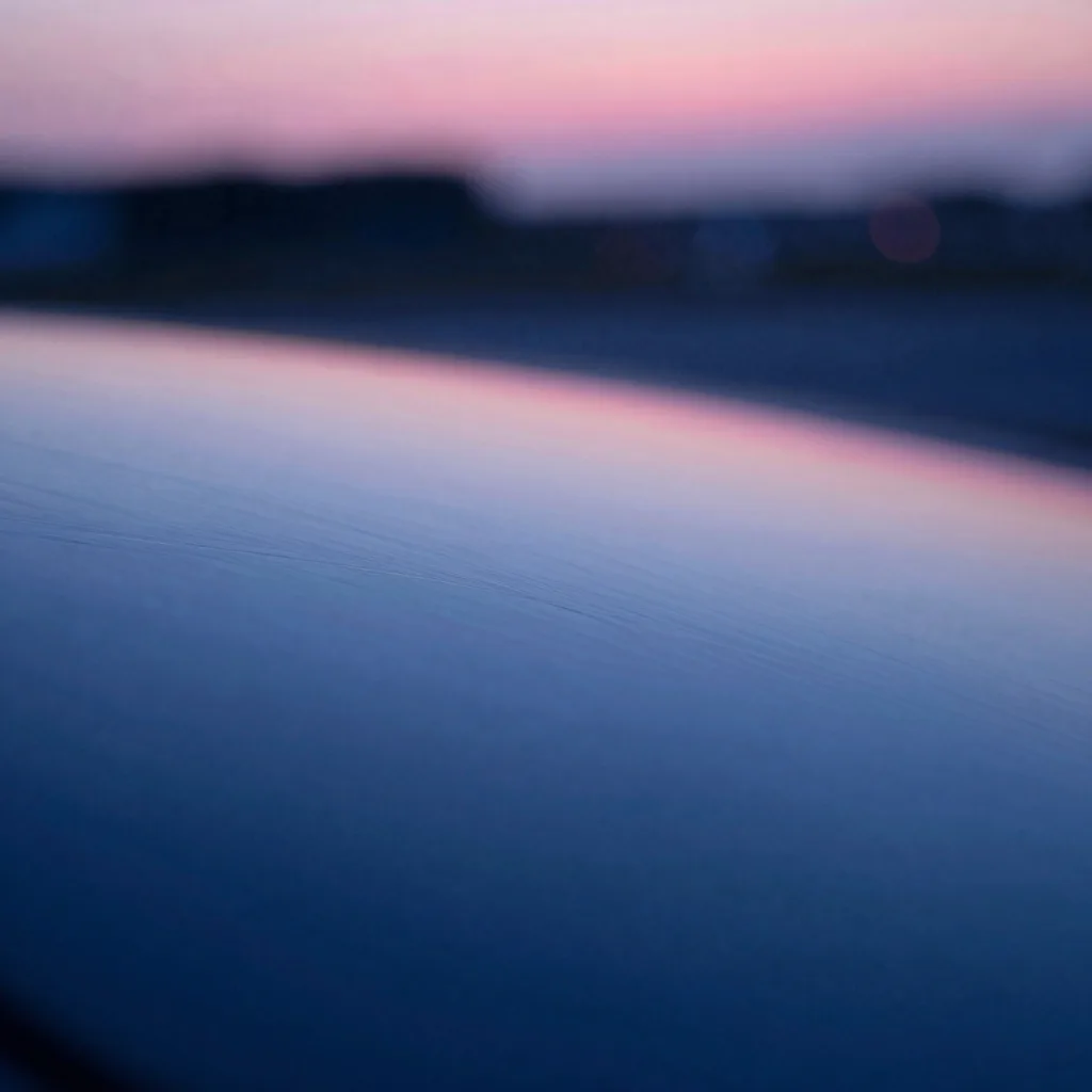 Close-up of a single translucent sheet showing internal refraction and subtle color shifts in the material.