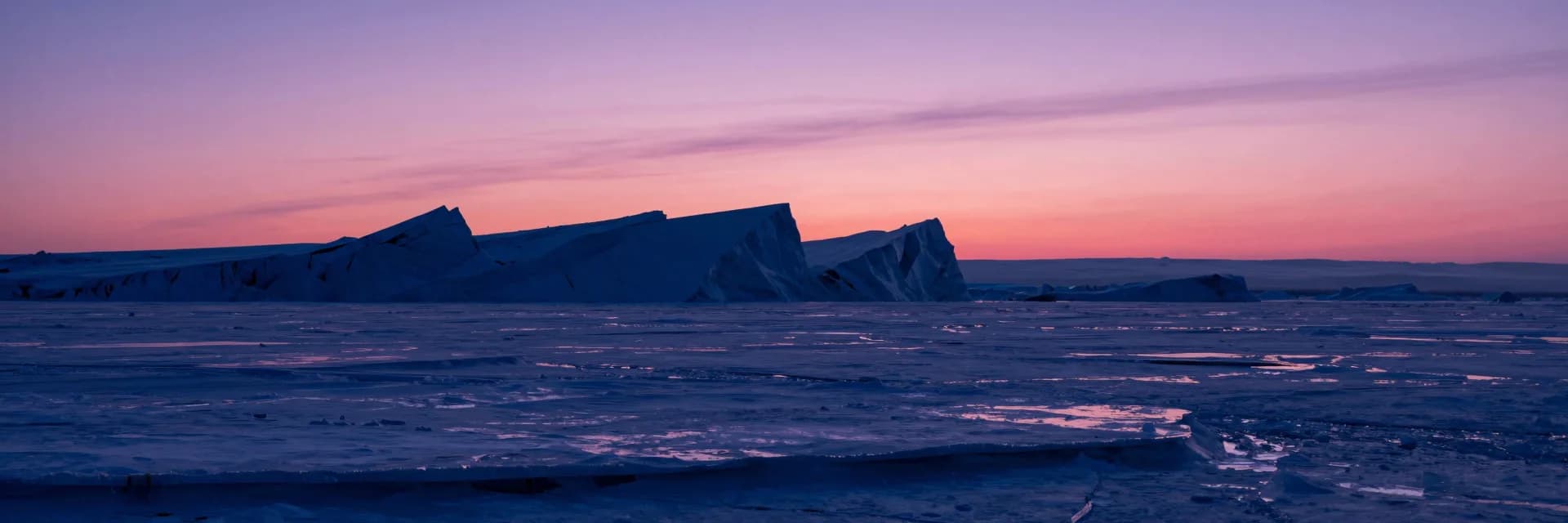 Ultra-wide vast frozen plain with strata barely visible across distance