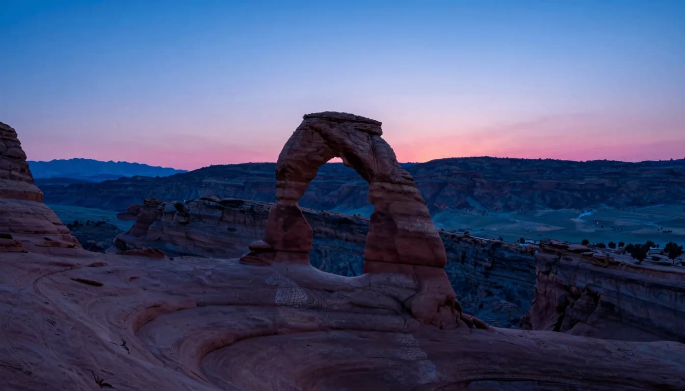 Distant ultra-wide of an abandoned monolithic structure on a vast plain, scale dwarfed by the deep blue horizon and a pink sky band.
