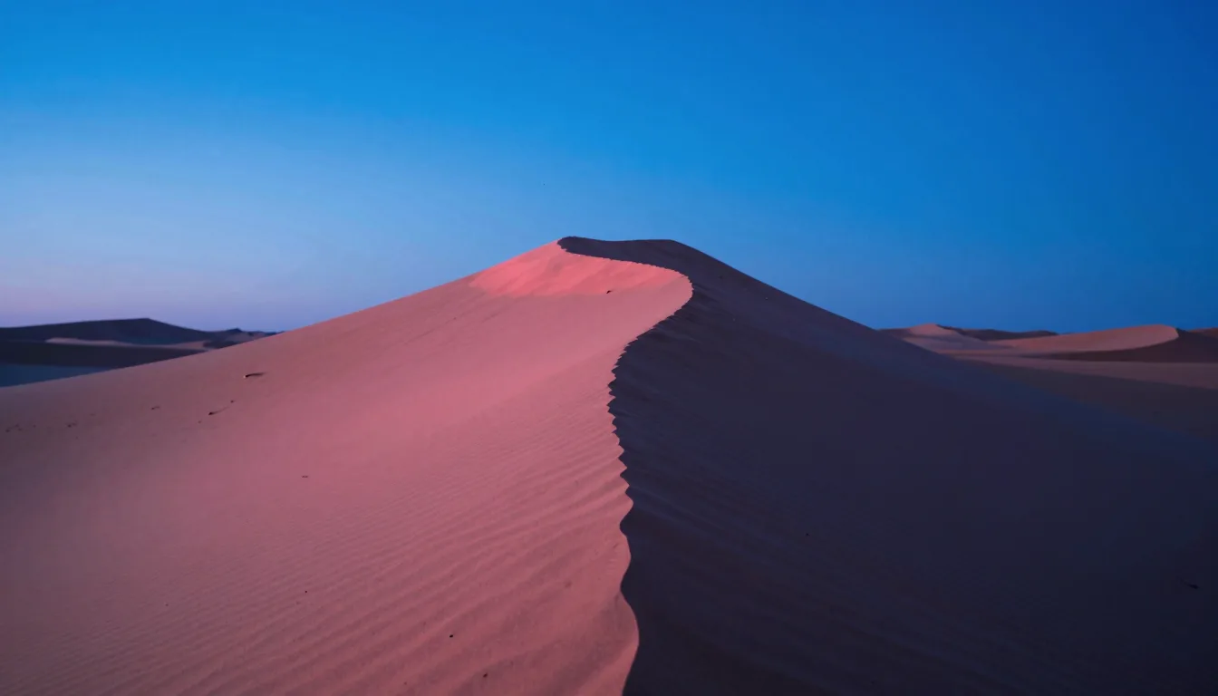 cinematic trail-aspect of dune ridge under electric-blue sky with hot-pink low sun grazing the crest - companion image for the Meta ads CBO vs ABO 2026 structure guide