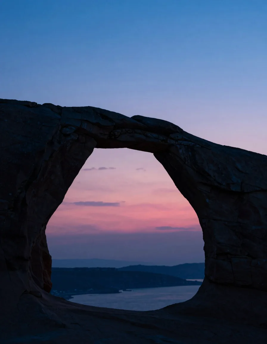 Ultra-wide backlit silhouette of a single tall translucent slab against a deep electric-blue evening sky, hot-pink magic-hour band along the low horizon.