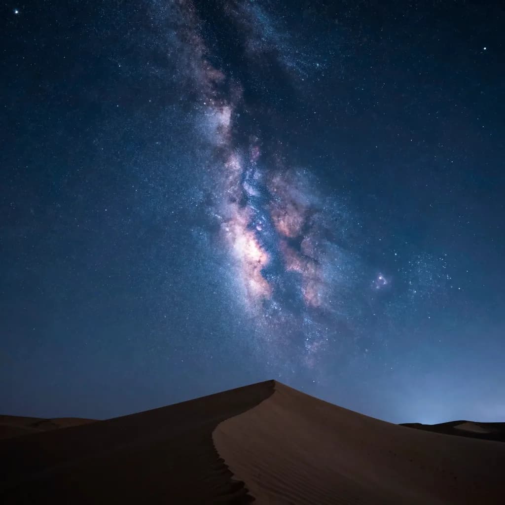 Vertical-emphasis composition of a single dune ridge silhouetted against the Milky Way.