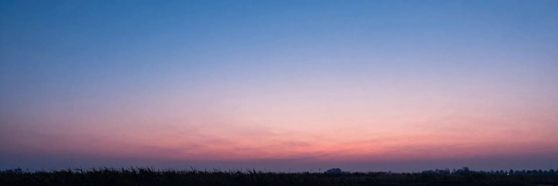 Ultra-wide pure-atmosphere of the gradient dawn sky transitioning from cool blue to warm pink near the horizon, no marsh or reeds.