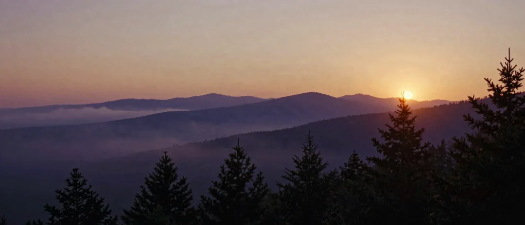 Layered Blue Ridge mountain ridges fading into a purple dawn haze.